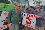 A group of farmers with 'Stop AusNet' signs