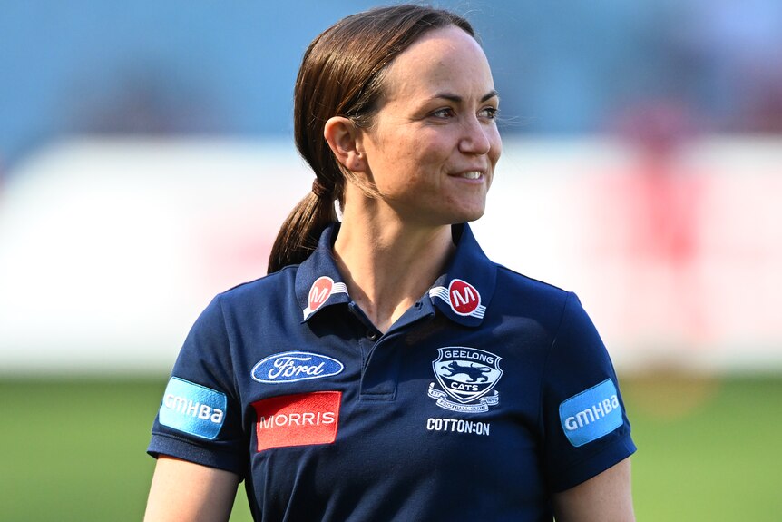 Daisy Pearce looks to her left while working as a member of Geelong's AFL coaching staff.