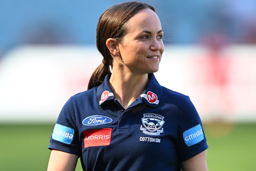 Daisy Pearce looks to her left while working as a member of Geelong's AFL coaching staff.