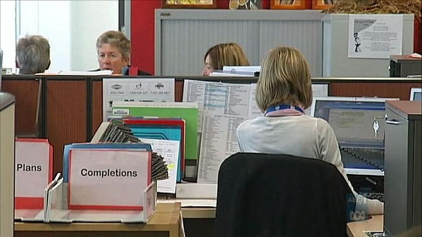 Public servants working at computers in an office in Canberra.