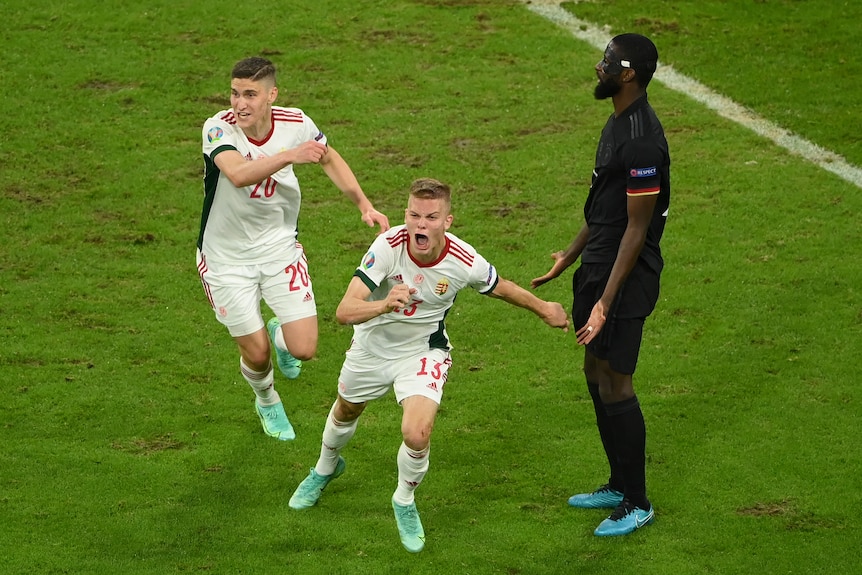 A Hungarian footballer roars in celebration as he sprints away from goal after scoring at Euro 2020. 