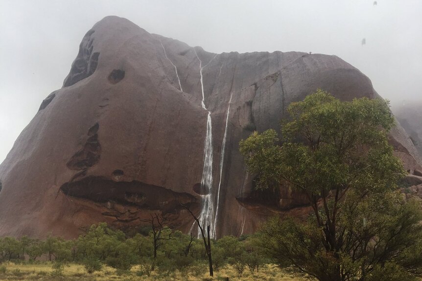 Waterfalls cascade down Uluru
