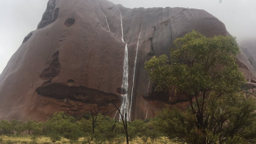 Waterfalls cascade down Uluru