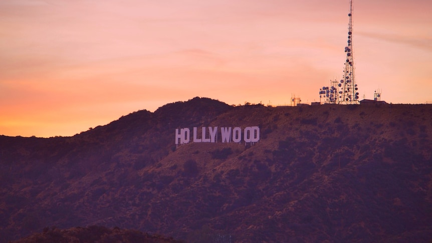 Hollywood sign lit at sunset