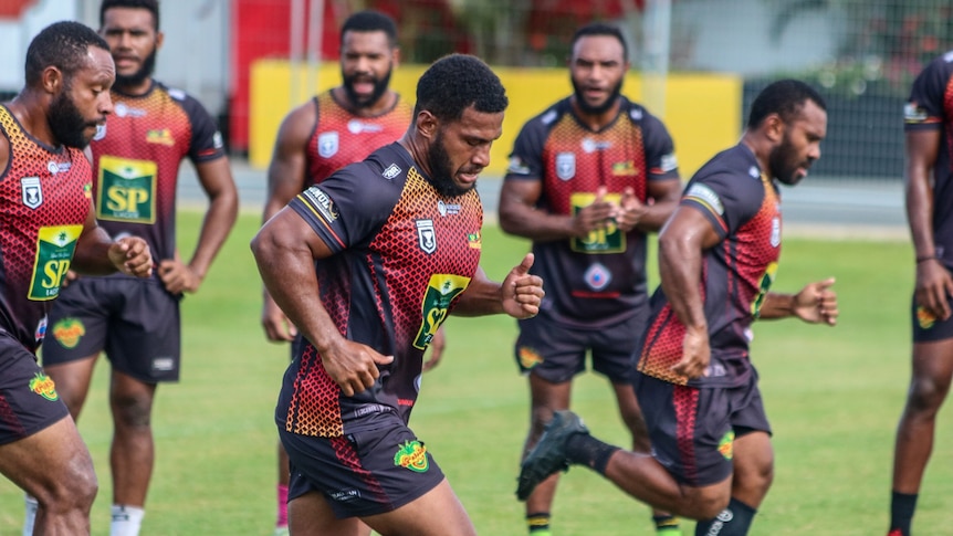 PNG Hunters mid frame shot of players running together on a field 