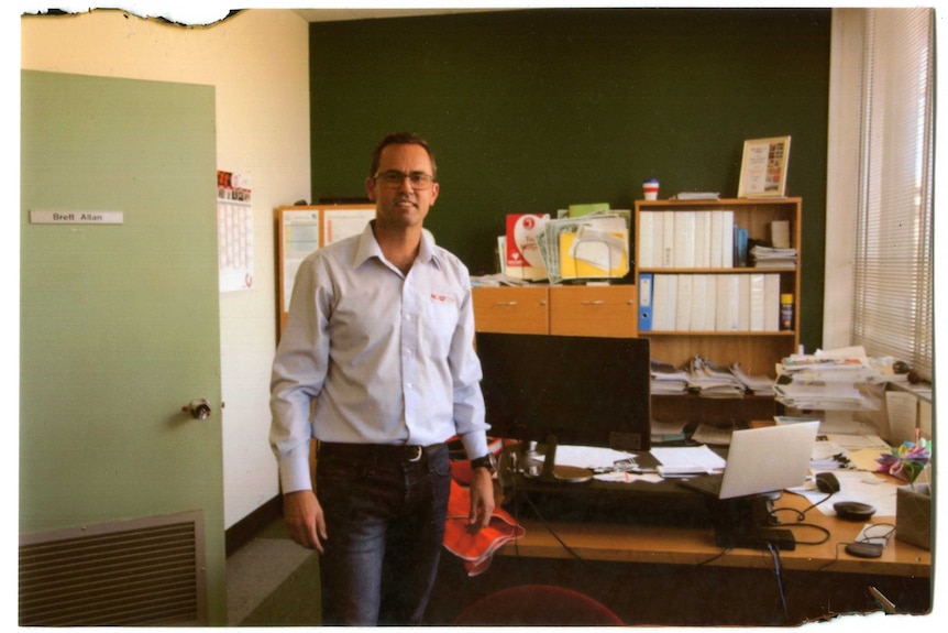 Brett Allen stands in his office.