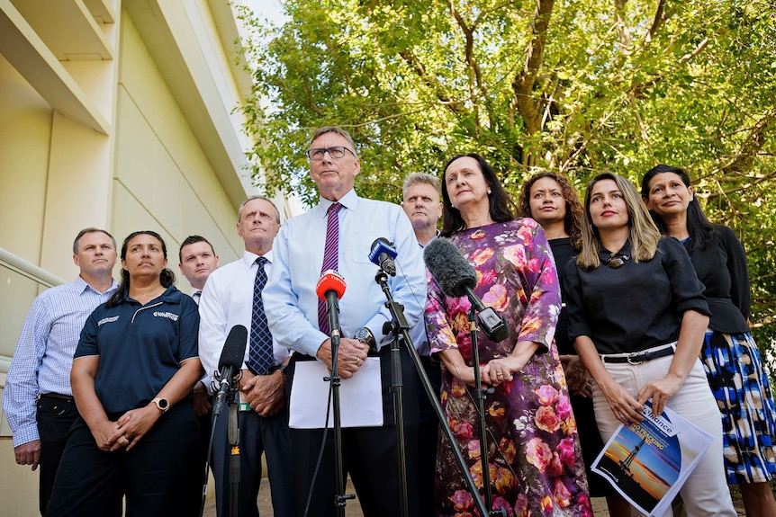 Territory Alliance members stand before a camera at a press conference. Leader Terry Mills is in the centre.