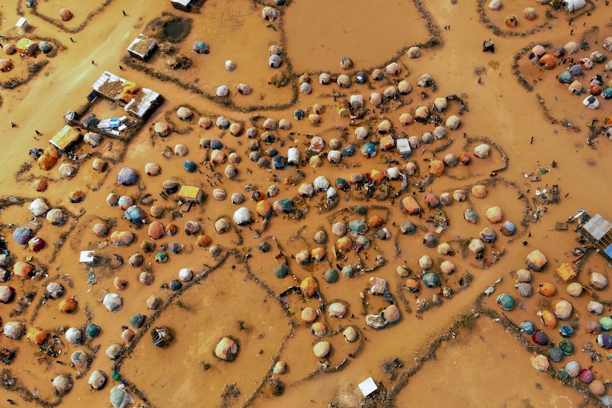 an aerial view of many huts made of branches and cloth in a camp in Somalia