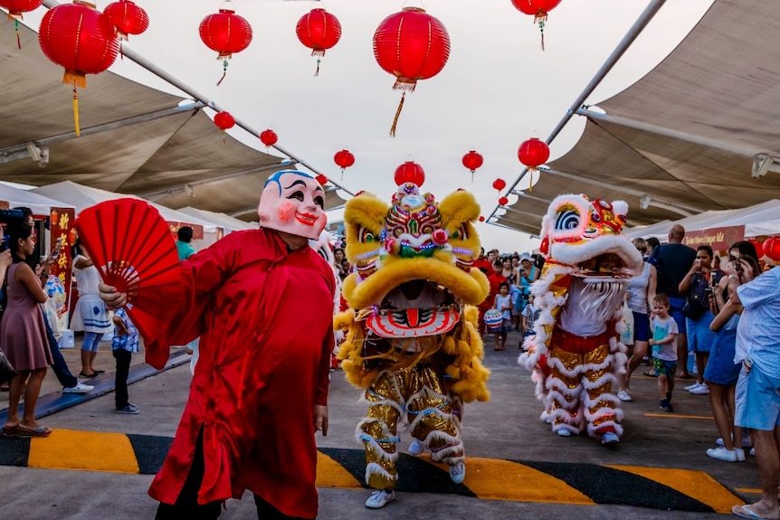 A traditional Chinese New Year lion dance on a rooftop