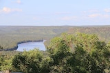 A photo of a vast escarpment with a river running through.