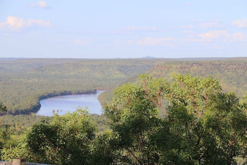 A photo of a vast escarpment with a river running through.