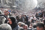 Residents wait to receive food aid distributed by the UNRWA in Syria