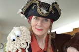 Karen Martyn dressed in a pirate costume holding a bowl of pasta