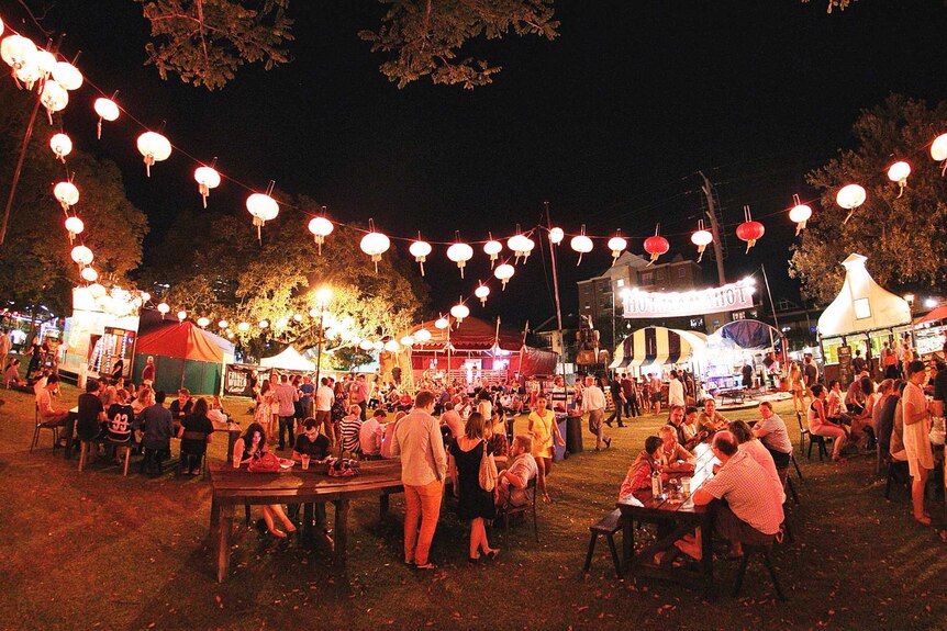 A wide shot of the Perth Fringe Festival's Pleasure Garden filled with people at night.