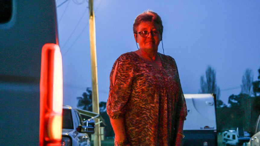 Gulgong showground caretaker Colleen Bailey standing behind Nightrider Community Bus