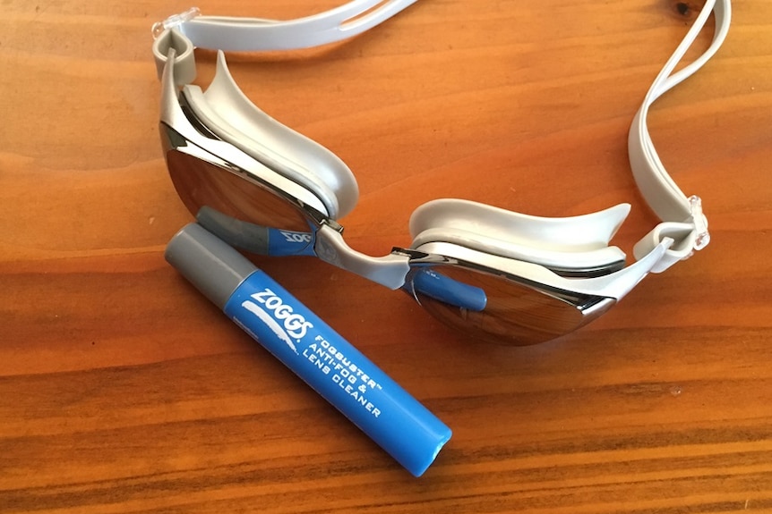 A pair of goggles pictured with the recalled Zoggs fogbuster anti-fog spray.