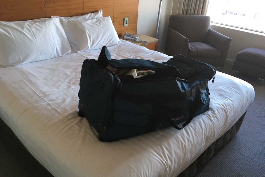 Bag on hotel bed.