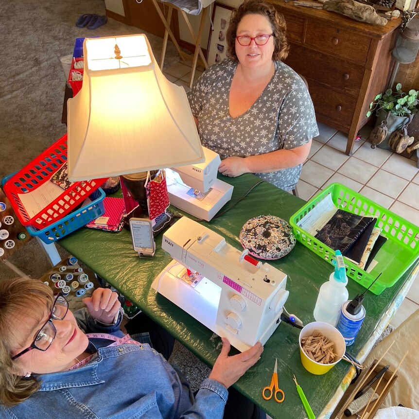 Becky Smith and Debbie Cobb sew masks in Texas during spring 2020.