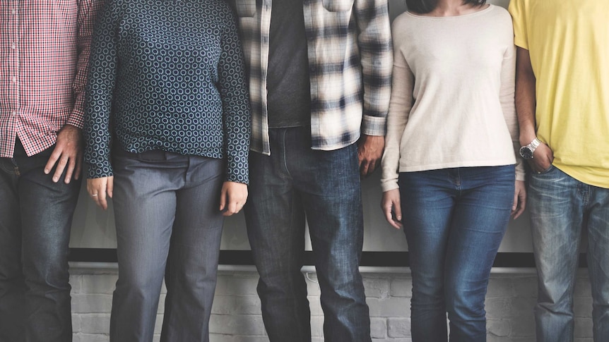 Five adults stand in a row