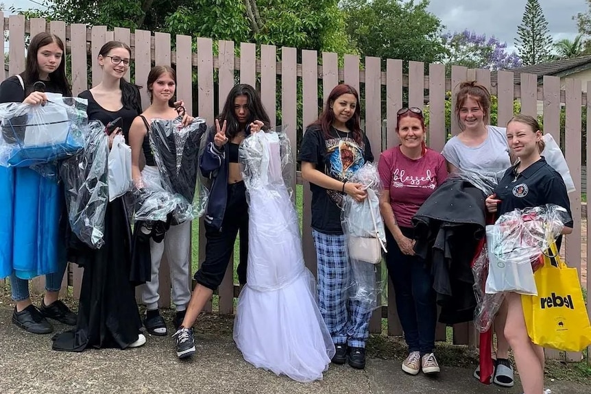 Tammy Robinson with some of the teenagers she has helped get dresses for their formal.
