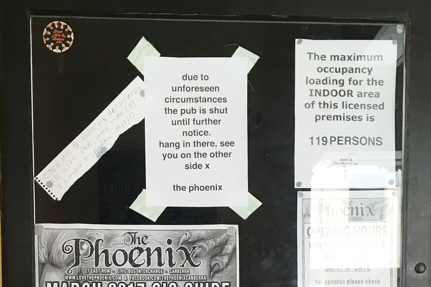 A sign explaining the pub is closed until further notice on the front door of The Phoenix.