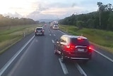 Dashcam footage of a stolen car about to crash into another on the Bruce Highway north of Townsville.