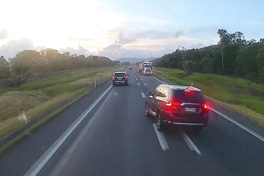 Dashcam footage of a stolen car about to crash into another on the Bruce Highway north of Townsville.