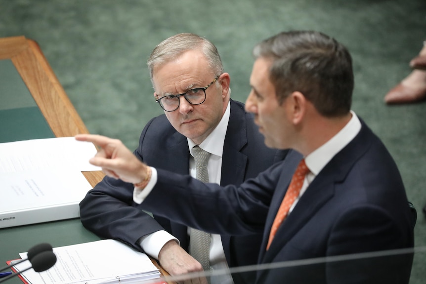 Albanese looks at Treasurer Jim Chalmers who is standing and speaking at the despatch box.