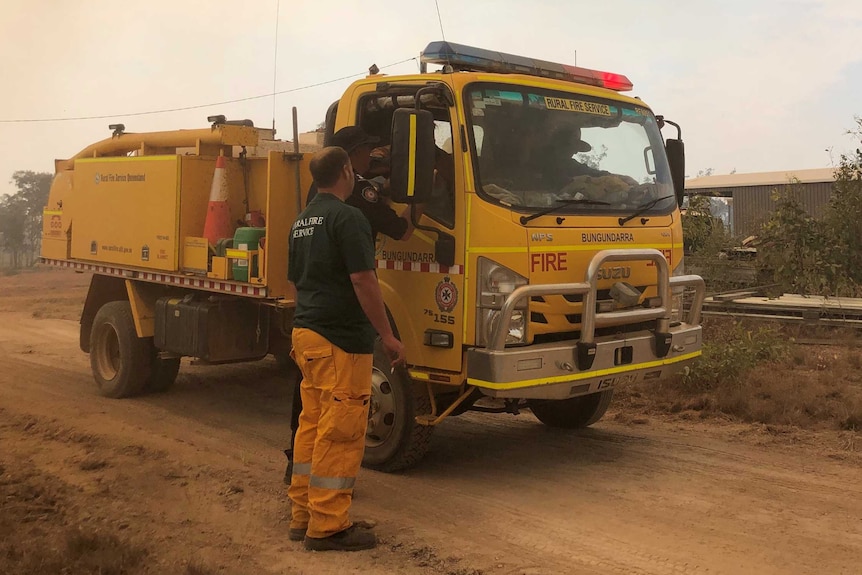 A Queensland Rural Fire Service crew with their truck near the Cobraball blaze.