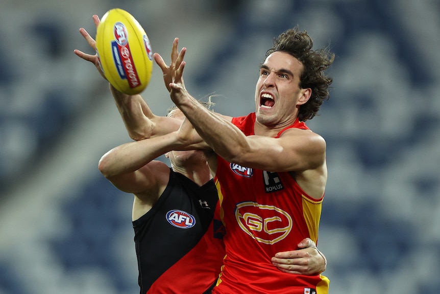 Ben King has his mouth open as he holds his hands out towards the ball