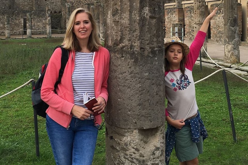 Emma Bowden and her daughter Heather pose on either side of a tree.