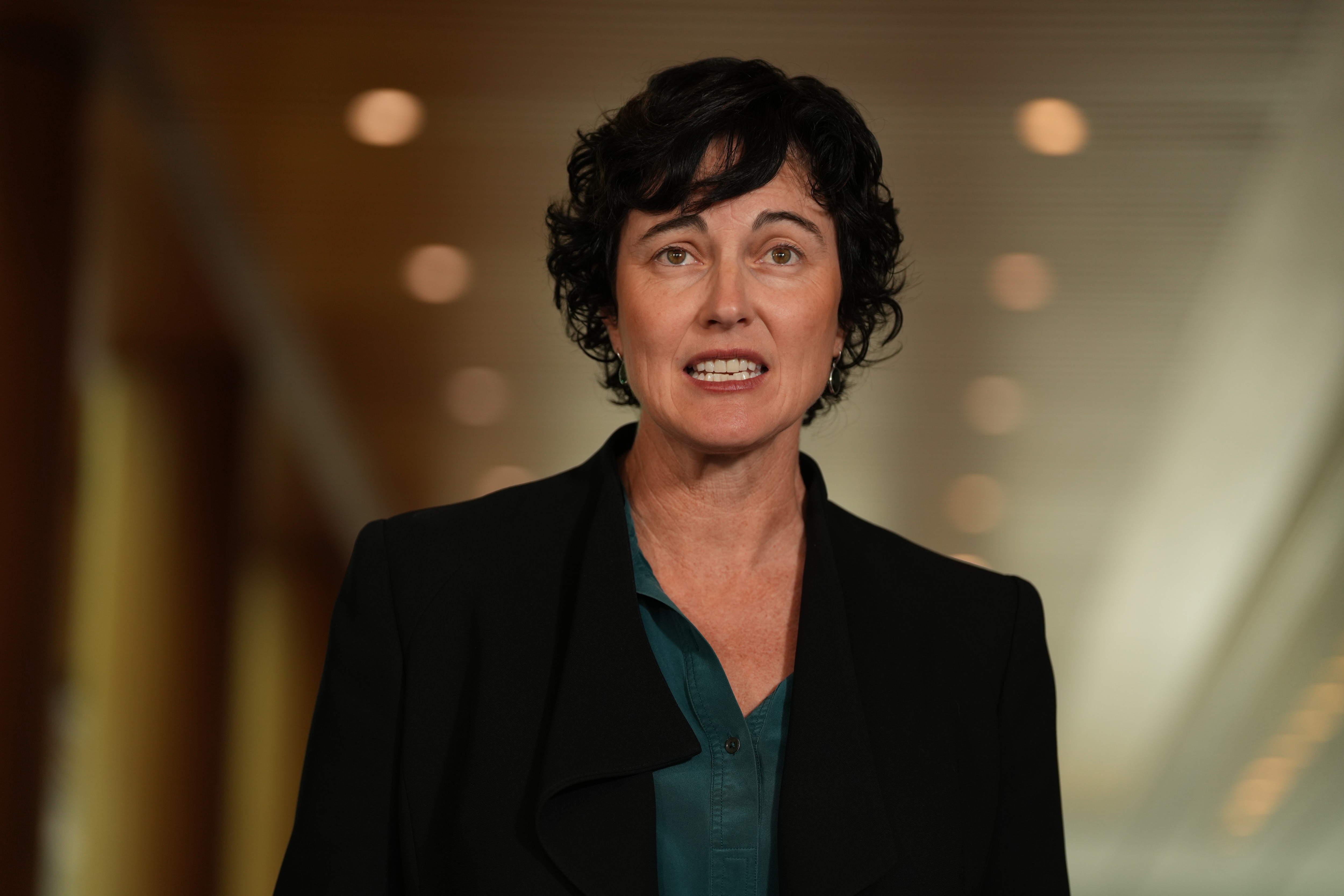 Kate Chaney in a black jacket and green shirt.