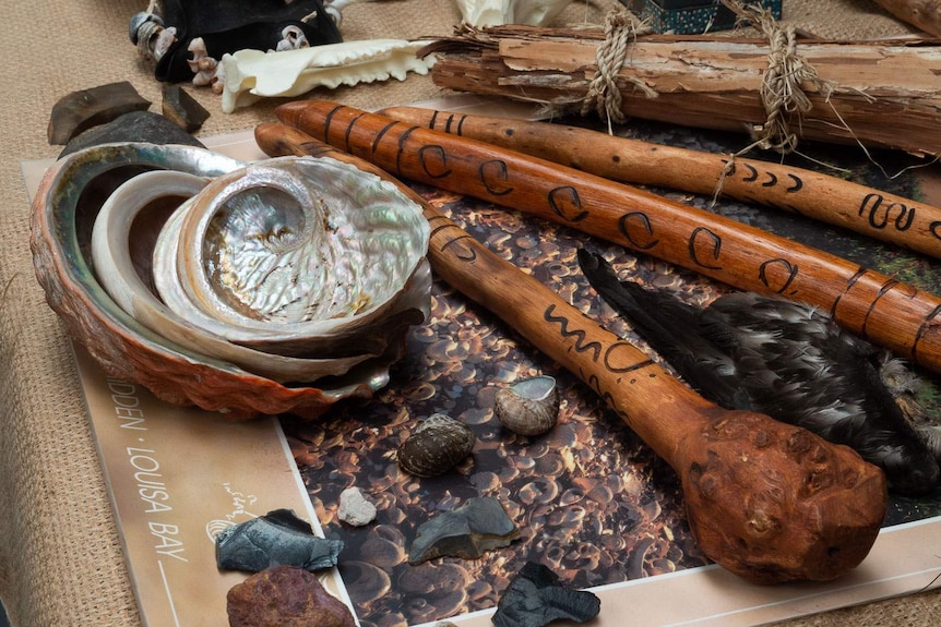 Waddy or wooden clubs, abalone shells and stone cutting tools on display in the shelter shed at Arthur River