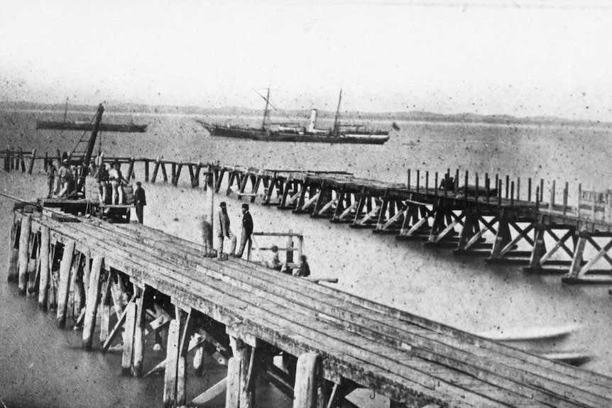 A black and white photo of two jetties. 