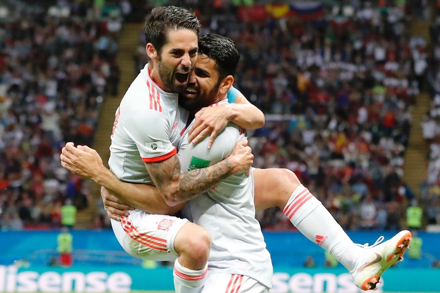 Diego Costa gets a hug from Isco
