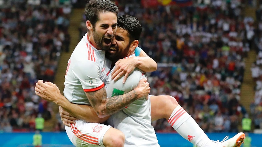 Diego Costa gets a hug from Isco