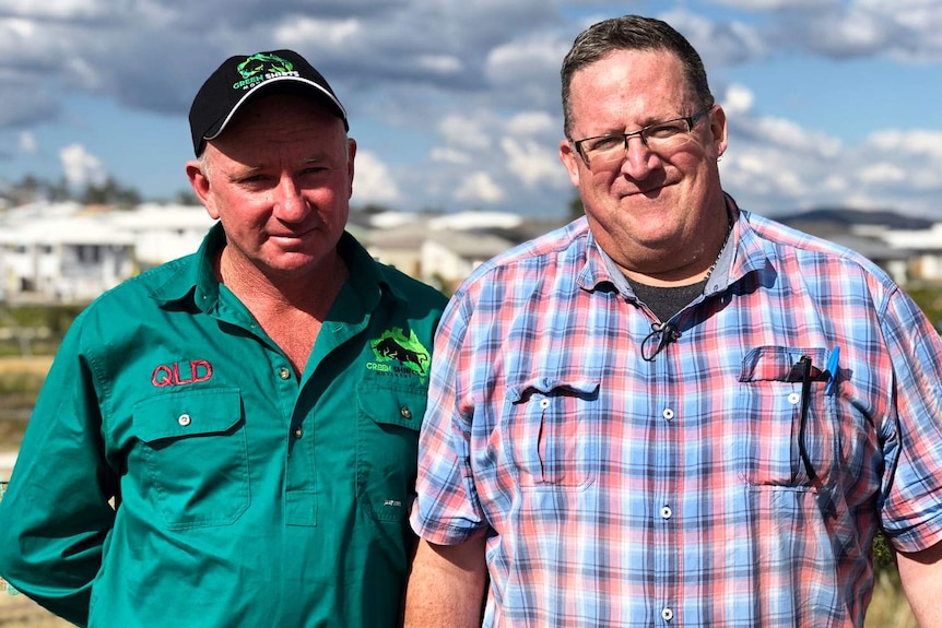 Farmer Jim Willmott and Biosecurity Queensland worker Jaimie Varcoe at a housing estate.