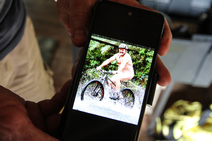 A photo of Michael Hayes naked on a bicycle. 