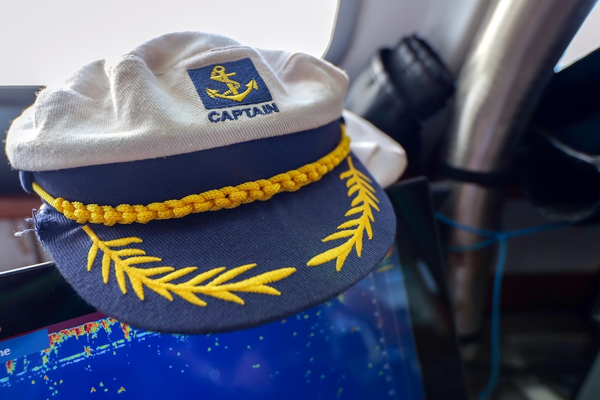 A sea captain's hat in the cabin of a ship.