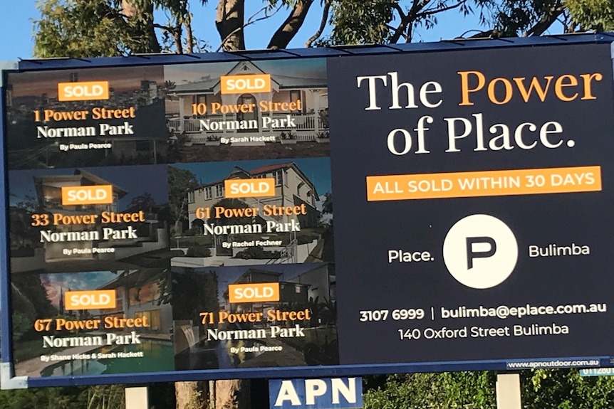 A black and yellow residential real estate sign showing six houses sold and the headline The Power of Place.