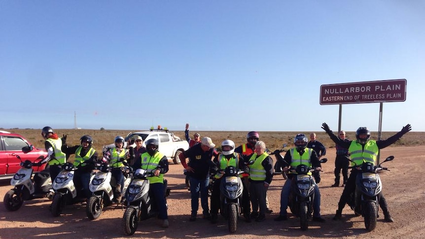 Seniors in mental health awareness drive: A group of senior citizens sit aboard their scooters on the Nullarbor Plain.