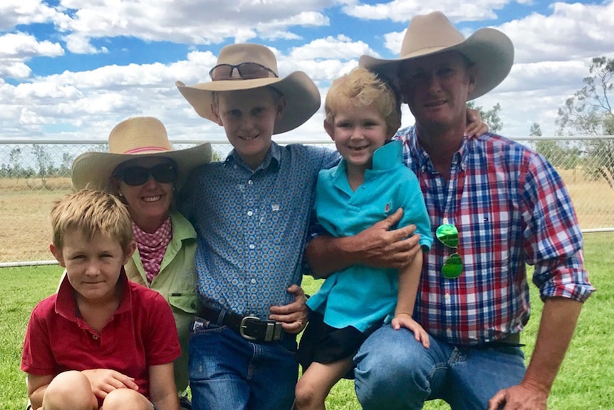 Danielle Doyle and her family of three kids and husband in a group photo.