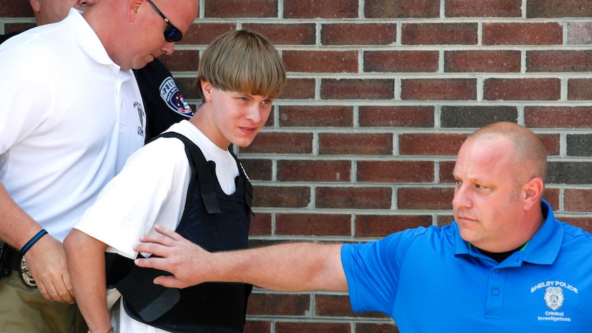 Police lead suspected shooter Dylann Roof into the courthouse