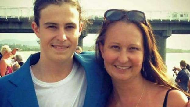 Mother and 21 year old son with his arm over his mum both smiling