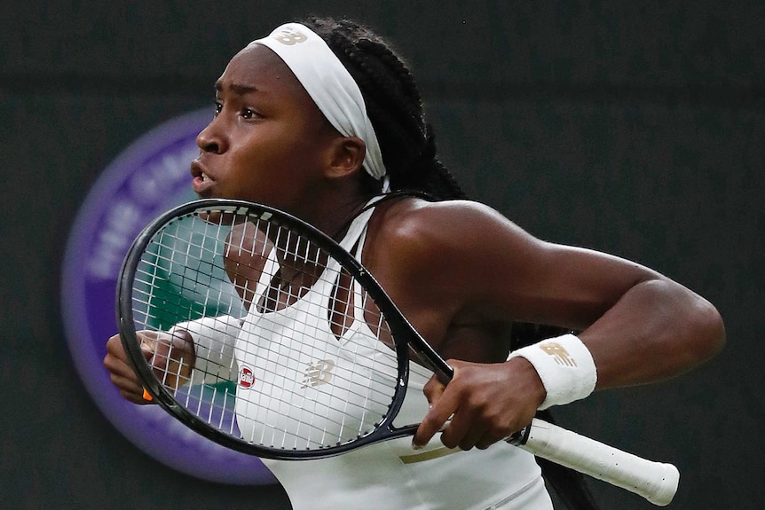 Coco Gauff pumps her arms in celebration, racquet in hand.