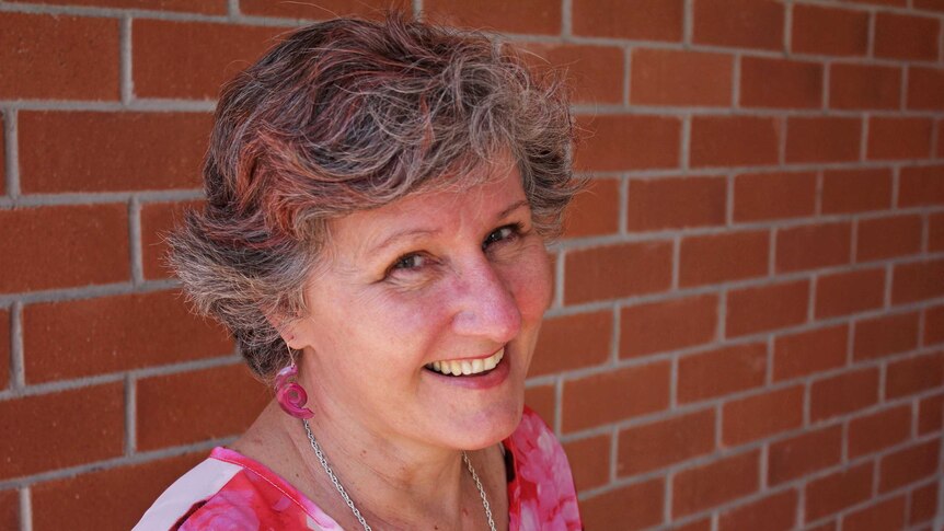 Lady with pink streaks in her hair smiling