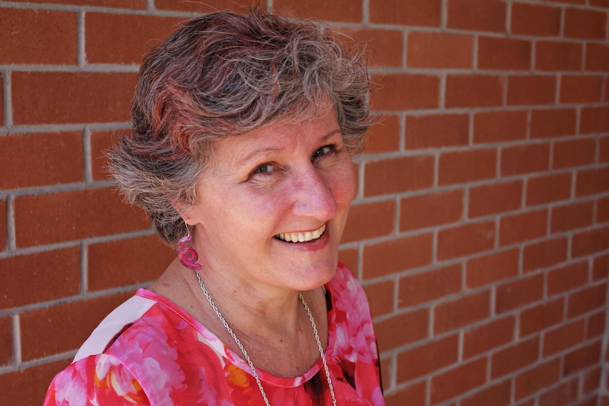 Lady with pink streaks in her hair smiling