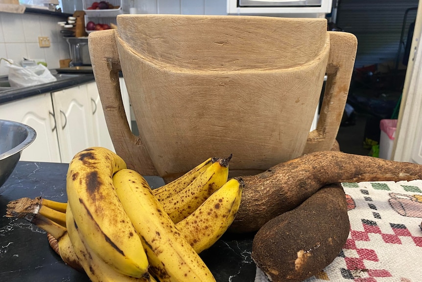 banana and cassava on table infront of mixing bowl. 