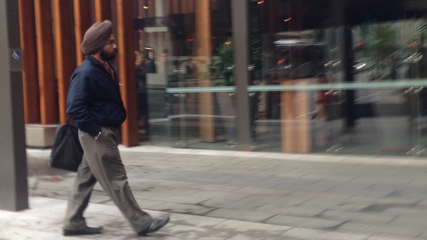 A man in a turban walks along a Perth street.