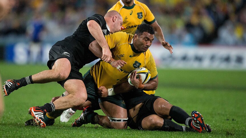 Wallabies number eight Wycliff Palu is tackled by the All Blacks